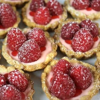 Little raspberry tarts topped with three raspberries each