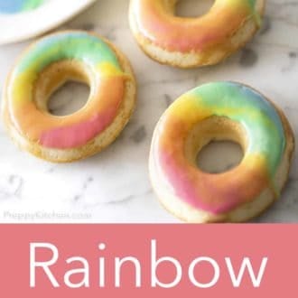 rainbow donuts on a white marble counter