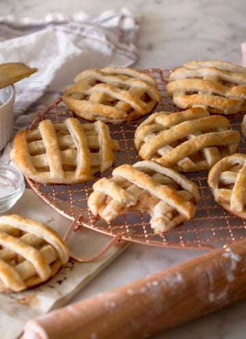 Apple pie cookies with a bite taken out of one.