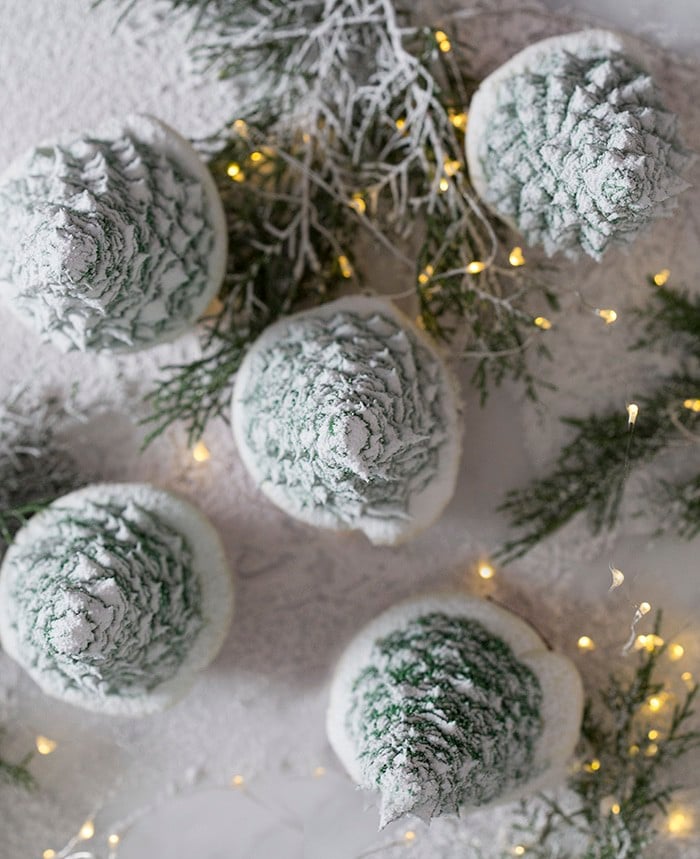 A top down photo of christmas tree cupcakes dusted with powdered sugar