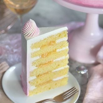 A photo of a champagne cake piece on a white plate