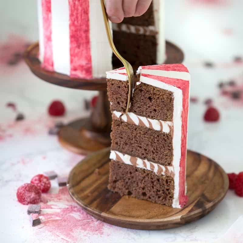 A bite being removed out of a slice of chocolate beet cake.