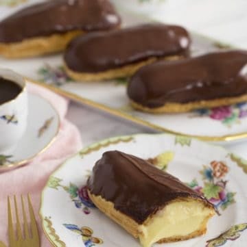 A photo of a chocolate eclair cut to expose the custard filling