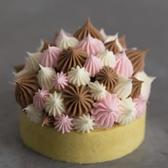 A photo of a Neapolitan tart with Swiss meringue buttercream dollops on top