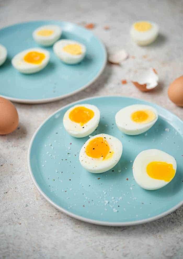 Instant Pot Hard Boiled Eggs plus how to make soft boiled and jammy eggs any way you like. The instant pot makes boiling eggs to your liking super easy, no more keeping an eye on the timer! #eggs #instantpot Instant pot hard boiled eggs and jammy cooked eggs on blue plates