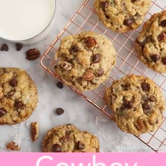 Pinterest graphic of an overhead view of cowboy cookies on cooling rack and a glass of mine beside it.