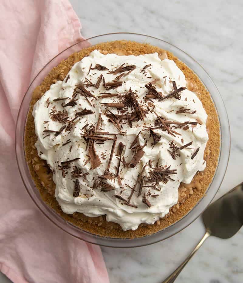 A top down shot of a banoffee pie on a marble table.