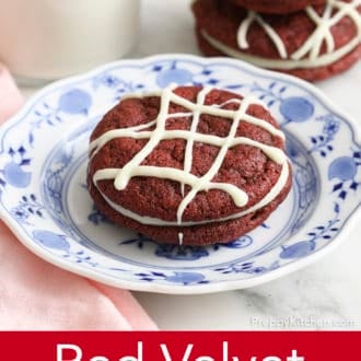 Pinterest graphic of a red velvet cookie on a plate with a stack of two in the background.
