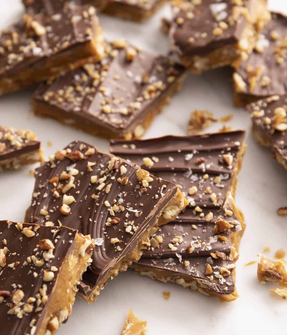 Pieces of toffee on a white marble counter.