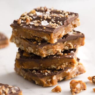 Four pieces of toffee on a marble counter.