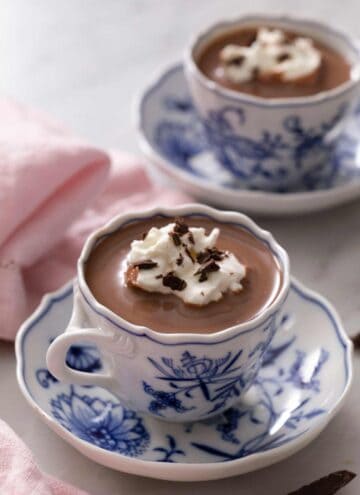 A blue china cup of hot chocolate. A second cup in the background.