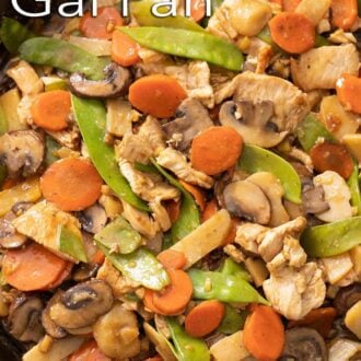 Pinterest graphic of an overhead view of a skillet of moo goo gai pan.