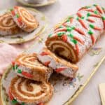 A close up of a carrot cake roll cut into slices