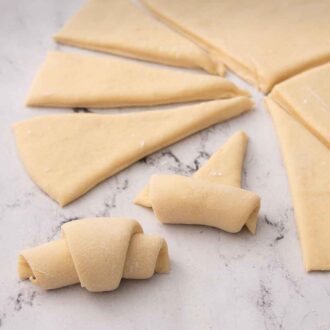 Pinterest graphic of crescent roll dough rolled up.
