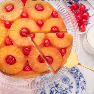 Pinterest graphic of a pineapple upside down cake with a cut slice being lifted,