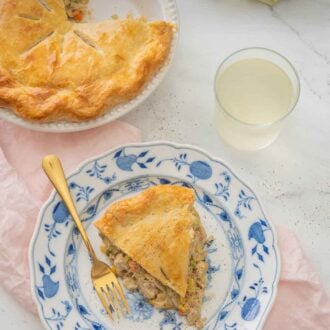 Pinterest graphic of a plate of turkey pot pie beside the cut pie over top of a pink linen napkin.