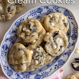 Pinterest graphic of an oval platter of cookies and cream cookies with a couple scattered around alongside Oreos.