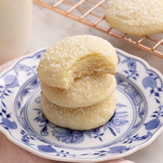 A stack of cream cheese cookies on a blue and white plate