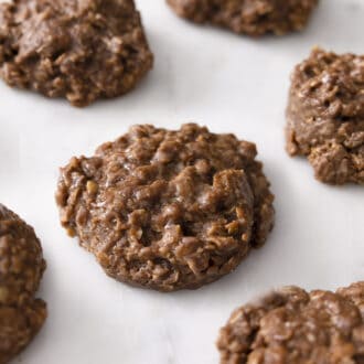 Chocolate peanut butter no bake bookies on a marble surface.