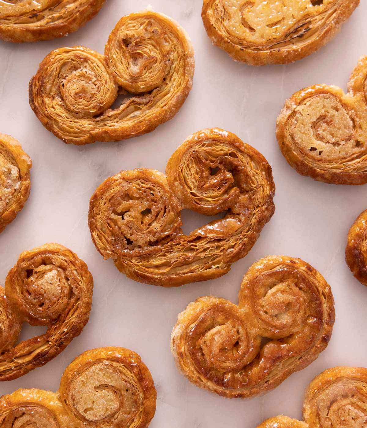 Multiple palmiers laid in a single layer on a marble surface.