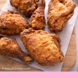 Pinterest graphic of six fried chicken on a paper towel on a cutting board.
