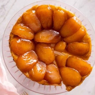 Overhead view of a tarte Tatin with a slice cut and pulled slightly away.