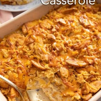 Pinterest graphic of a chicken casserole in a baking dish with a spoon inside.