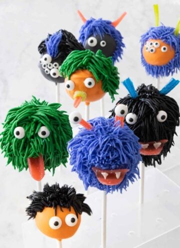 Eight Halloween cake pops decorated like monsters.
