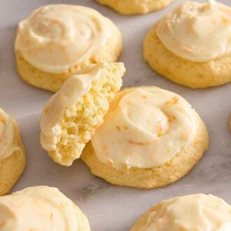 Multiple orange cookies in a single layer with one propped up.