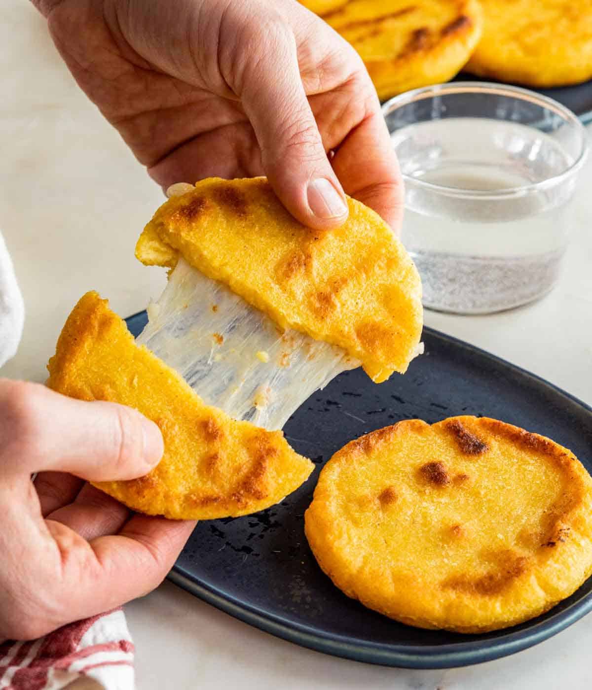 An arepa pulled apart, in half.