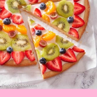 Pinterest graphic of a fruit pizza with two slices cut and slightly pulled away from the pizza.