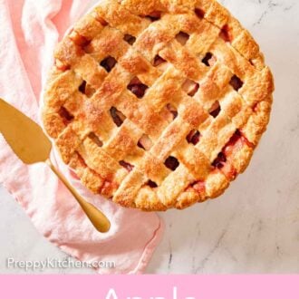 Pinterest graphic of an overhead view of a whole apple cranberry pie with fresh apples on the side and a linen beside it.