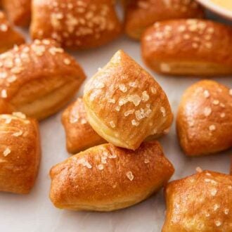 Close up of a pile of pretzel bites with coarse sea salt sprinkled on top.