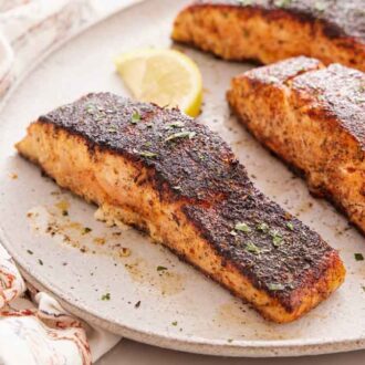 A close view of a platter with blackened salmon.