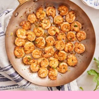 Pinterest graphic of an overhead view of a skillet of sautéed shrimp.