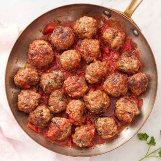 Overhead view of a skillet of meatballs tossed in sauce.