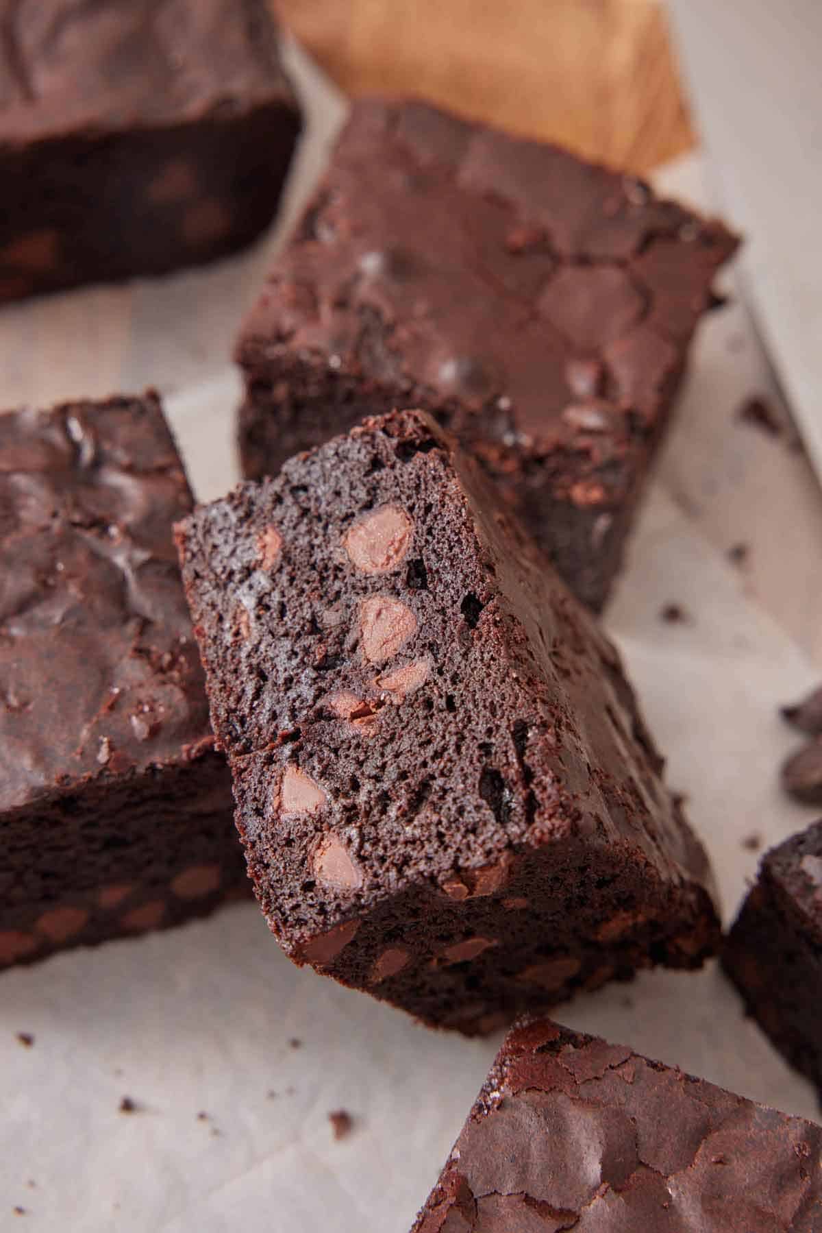 A brownie leaning on another, showing the interior cut-side.