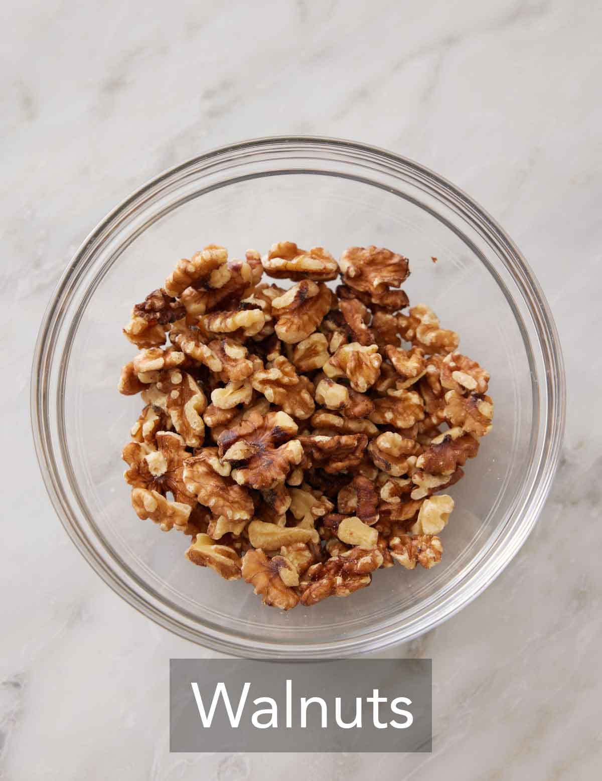 Overhead view of a bowl of walnuts.