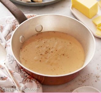 Pinterest graphic of a saucepan containing gravy with a plate of turkey, mashed potatoes, and green beans in the background and sliced butter.