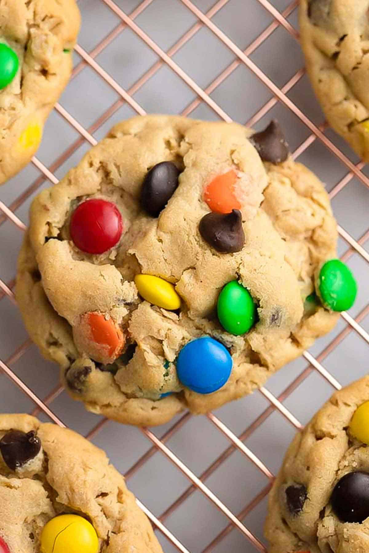Overhead view of monster cookies on a wire rack.