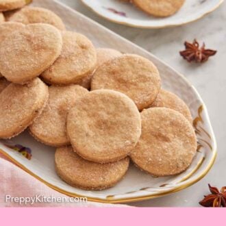 Pinterest graphic of a platter of biscochitos with a plate with a couple in the background.