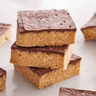 A stack of three Special K bar with more around it.