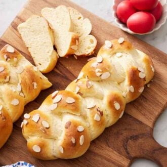 Overhead view of two leaves of tsoureki with one loaf half sliced.