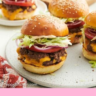 Pinterest graphic of smash burgers on a platter and one on a plate in the background.