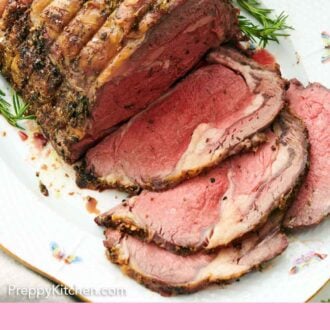 Pinterest graphic of prime rib on a serving platter with four slices cut in front.