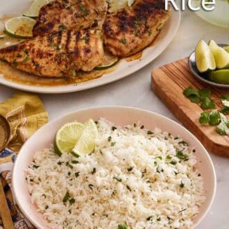 Pinterest graphic of a bowl of cilantro lime rice with grilled chicken in the background. Cut limes and cilantro on the side.