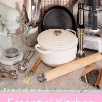 Pinterest graphic showing a stand mixer, immersion blender, Dutch oven, and more essential kitchen tools & essentials on a countertop.