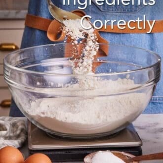 Pinterest graphic showing flour spooned into a bowl containing more flour on a kitchen scale. More baking ingredients in the foreground.