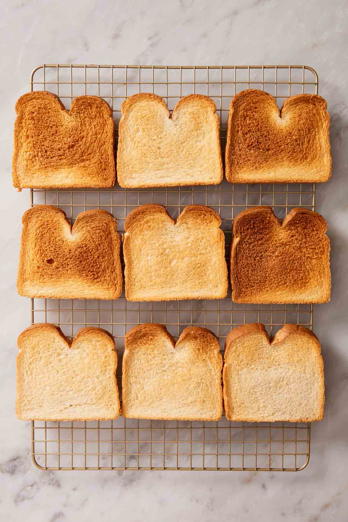 Overhead shot of slices of toasted bread on a wire rack.