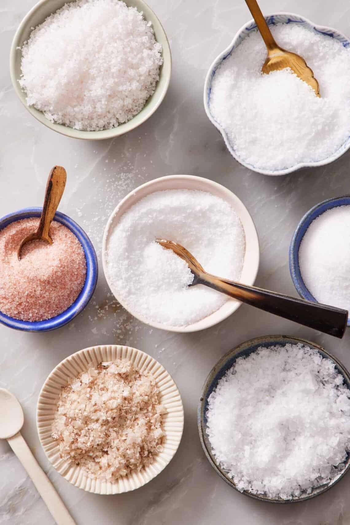 Overhead shot of bowls of different types of salt.